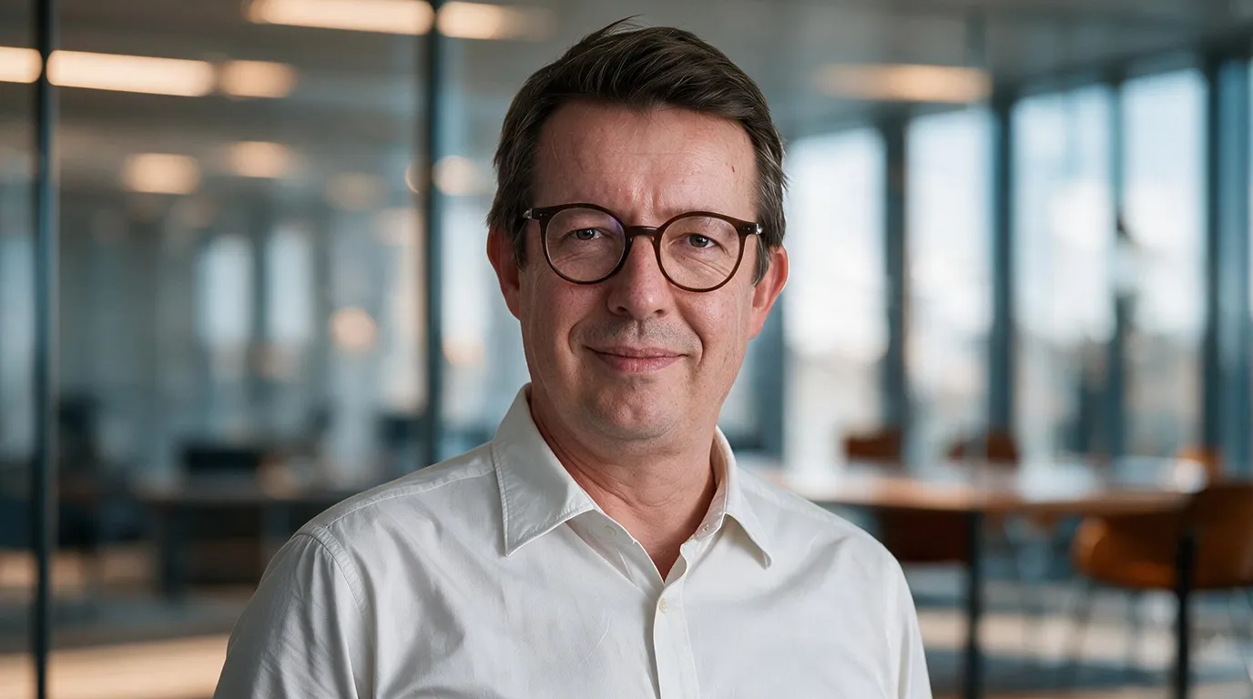 Picture of Benelux partner Tom Van Dyck in front of office window
